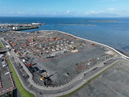 Aerial view of construction site surrounded by the sea.