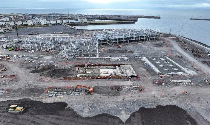 Aerial overview of the community campus progress, showing the erected structure and ground works