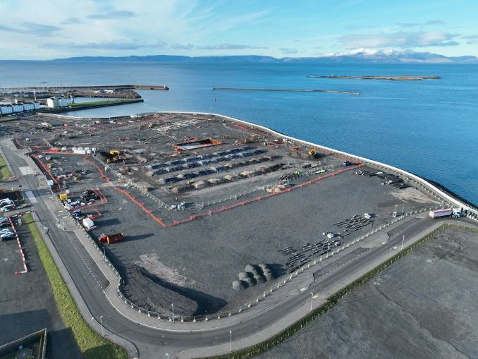 Aerial view of campus building site surrounded by the sea.