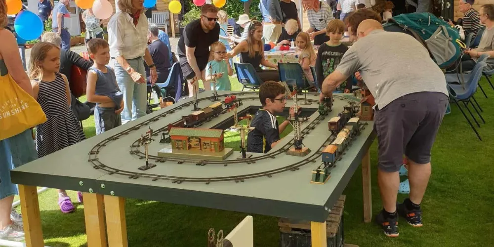 Families around a model train track