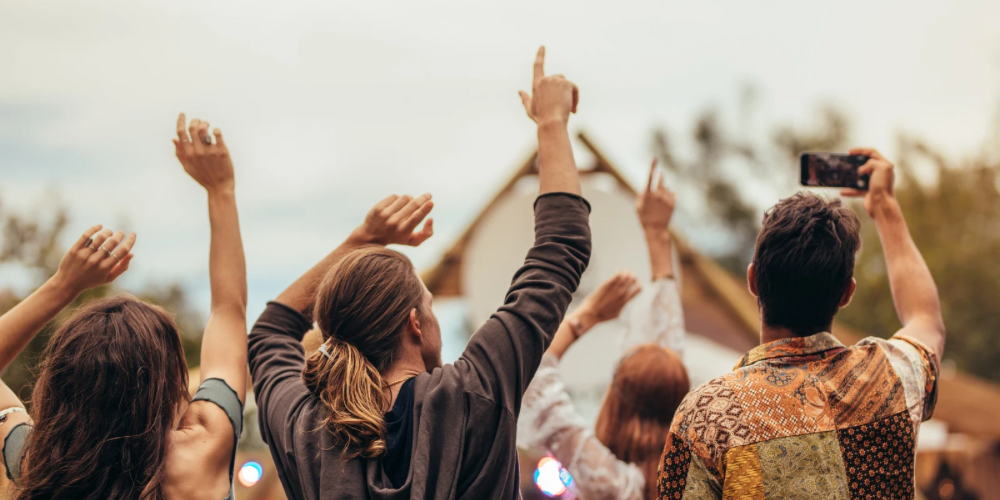 People dancing and celebrating at a concert