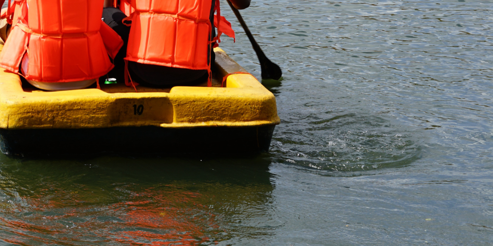 Raft in water with two people on board