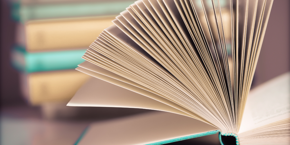 Close up shot of an open book with its pages fanned out.