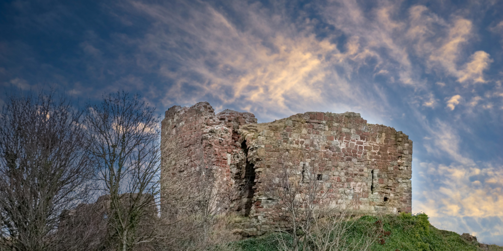 Ardrossan Castle with a cloudy blue sky in the background