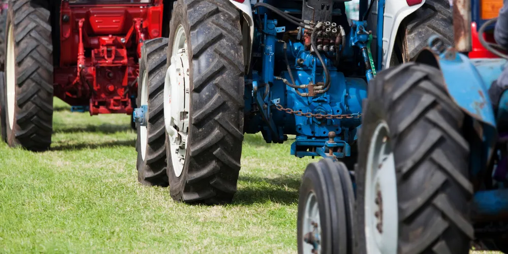 The wheels of three tractors in a field