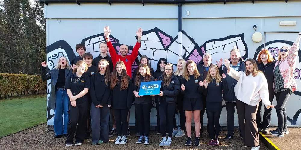 Members of Arran Youth Foundation celebrate outside hub