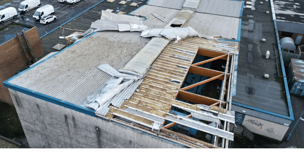 An aerial view of a building with a damaged roof