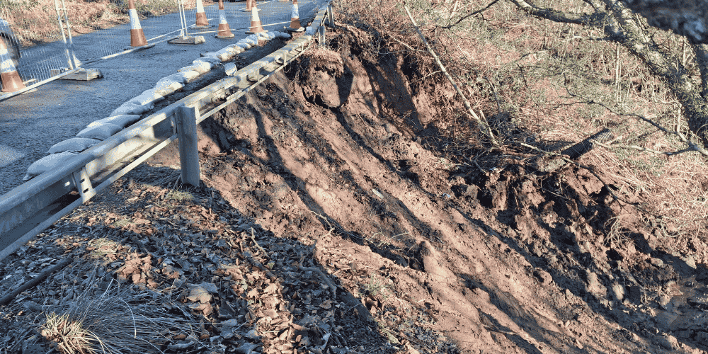 The side of a road which has suffered a landslip