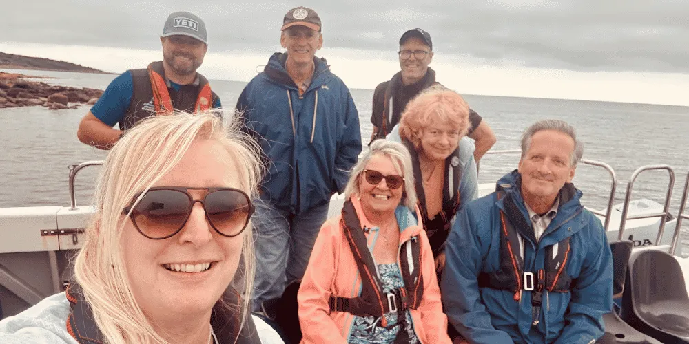 A group of seven people on board a small boat