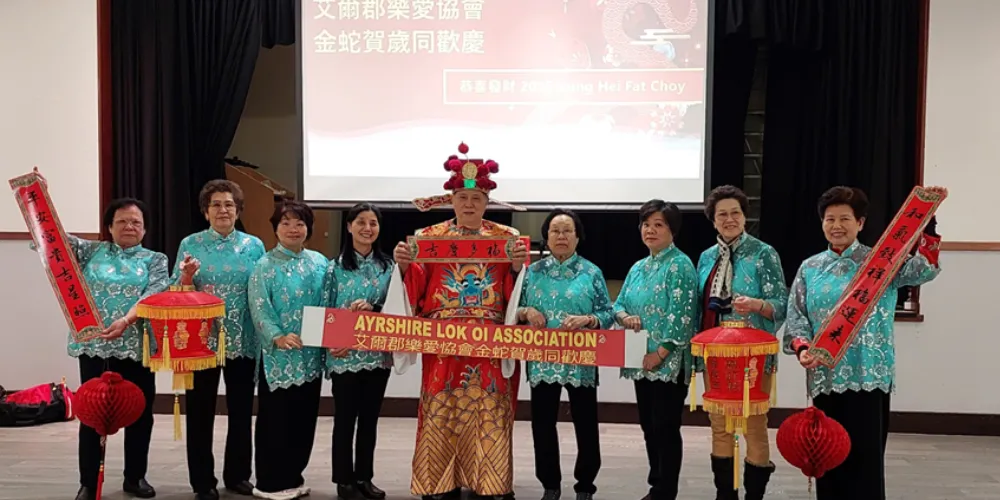 Group photo of Ayrshire Lok Oi Association in ceremonial dress