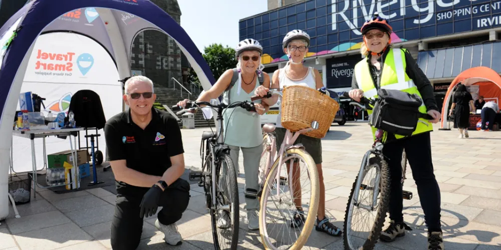 Group photo at Clean Air Day Dr Bike workshop with three cyclists