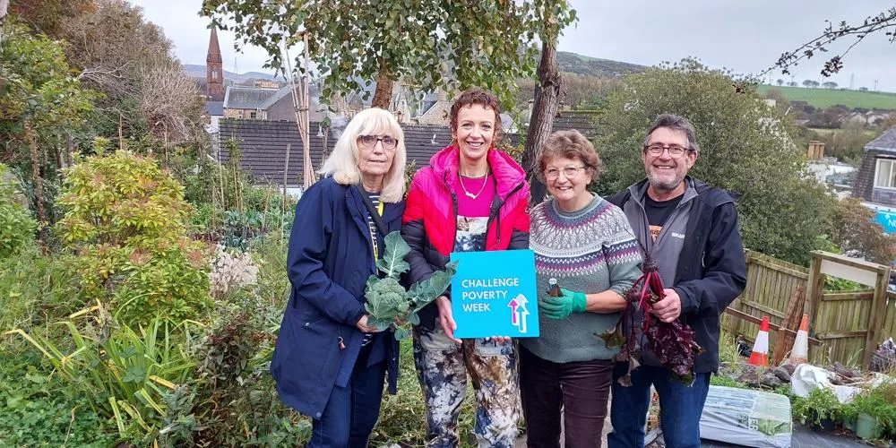 Four people standing in a garden