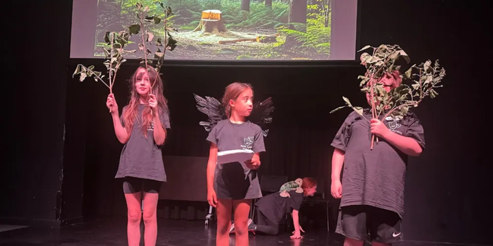Young people drama performance with tree branch props