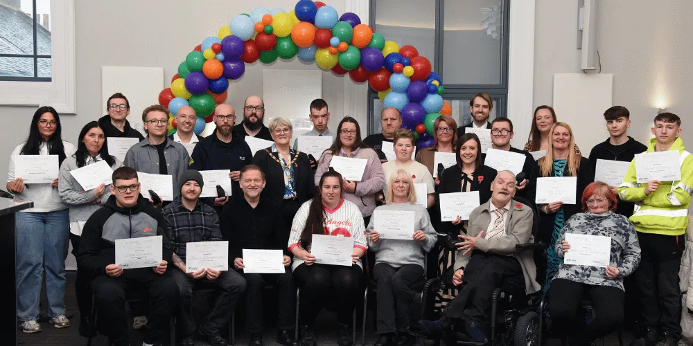 Winners and finalists standing in a big group holding certificates