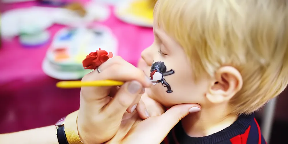 A child having their face painted