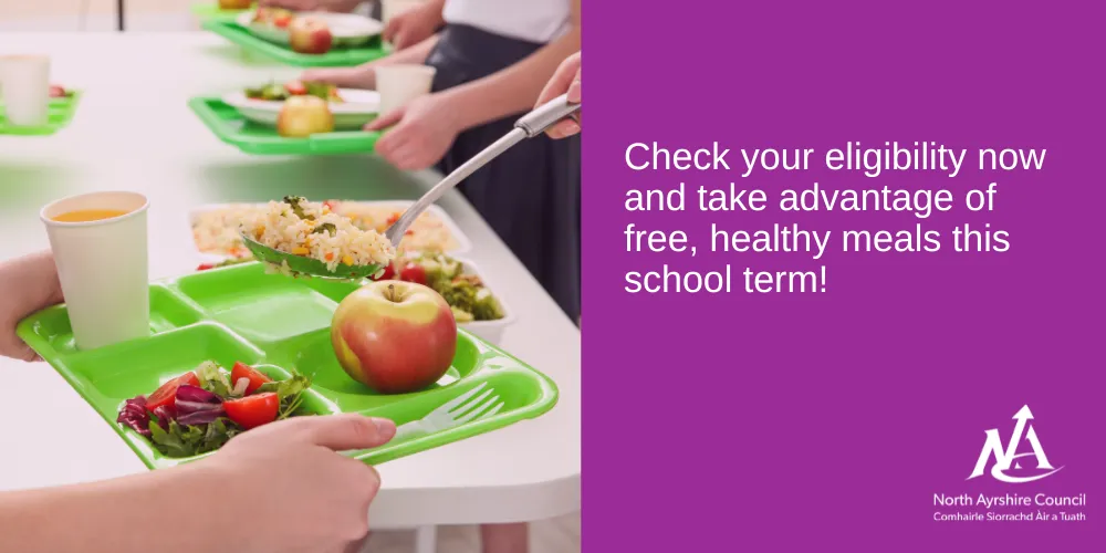 School lunch tray with healthy salad and apple with text that reads check eligibility now and take advantage of free school meals