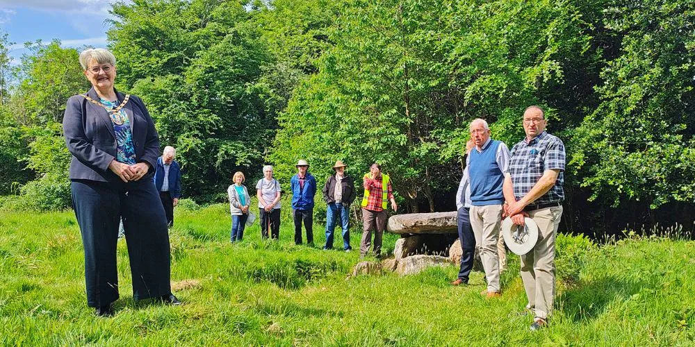 Provost and community member next to the Haylie Neolithic Tomb