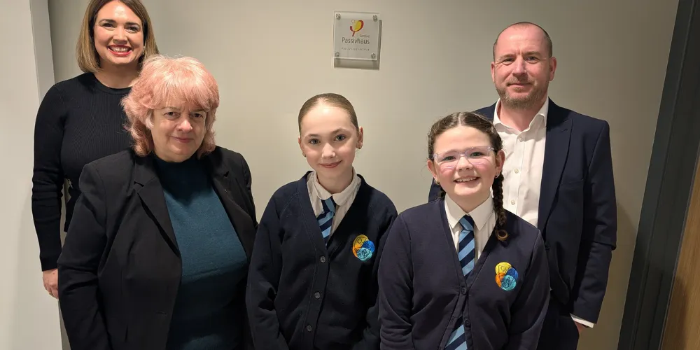 Head teacher Fiona Smyth, Councillor Collier, pupils Roma  and Marnie, Robertson’s Commercial Director Duncan Coyle at the new plaque to signal Passivhaus certification