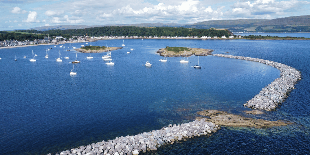 Millport flood protection scheme on a sunny, bright day with boats bobbing about on the water