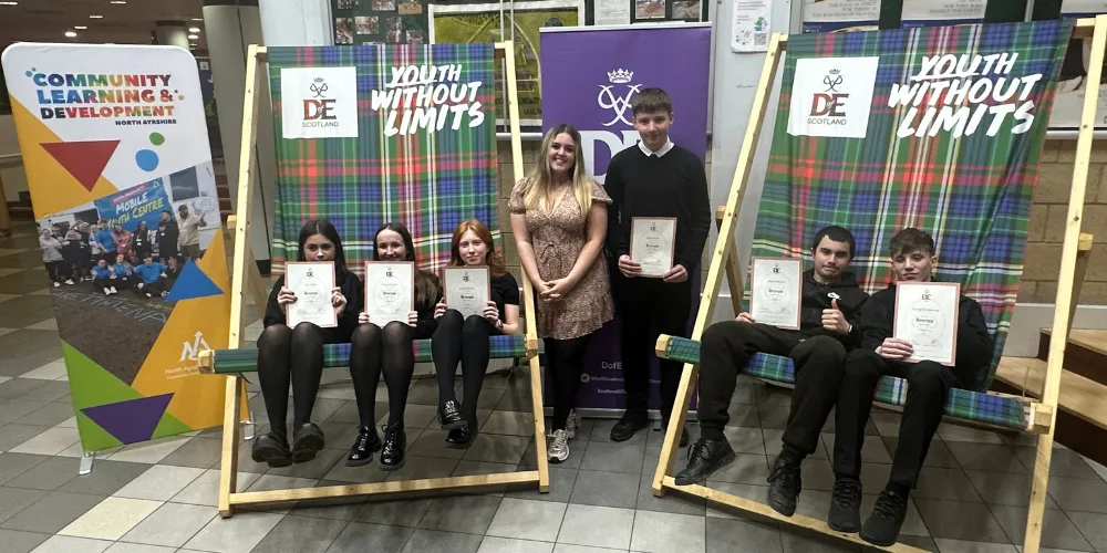 Young People's Champion between two giant deckchairs at Duke of Edinburgh Awards with winners from Greenwood and Irvine Royal