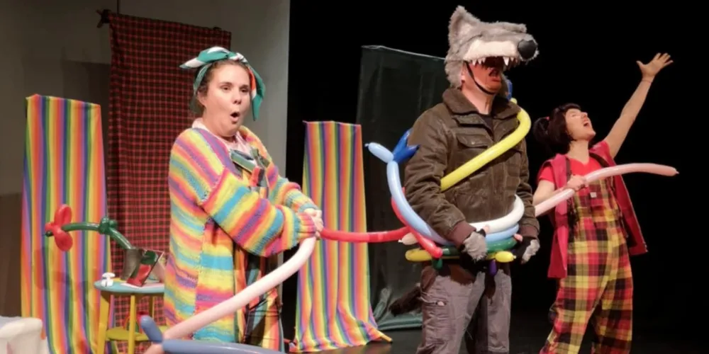 Three children's entertainers with balloon models and wolf mask