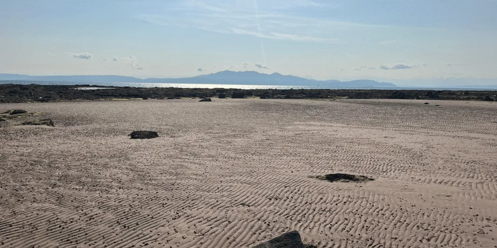 Seamill beach on a sunny day with Arran in the background