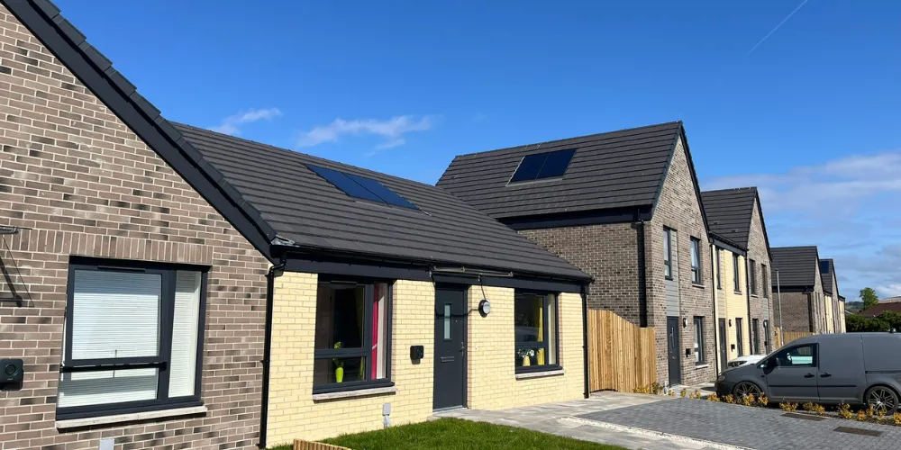 A view of a row of houses with blue sky overhead