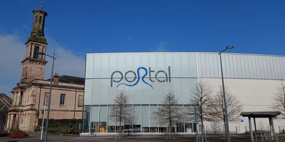 A leisure centre building on a bright day with blue sky above