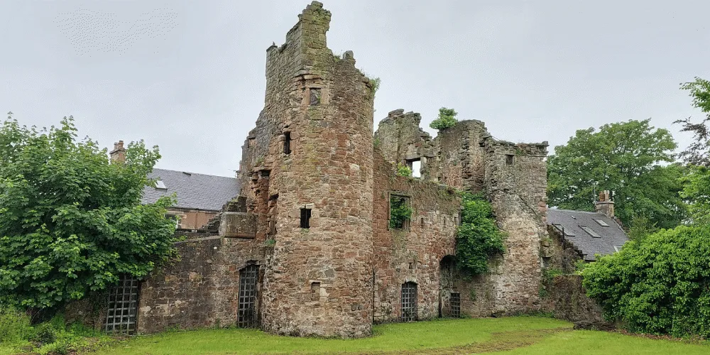 A castle ruin surrounded by green trees