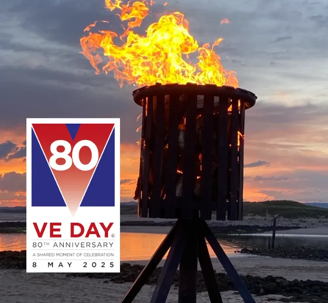 VE Day 80 logo with lit beacon with flame at Irvine Harbourside