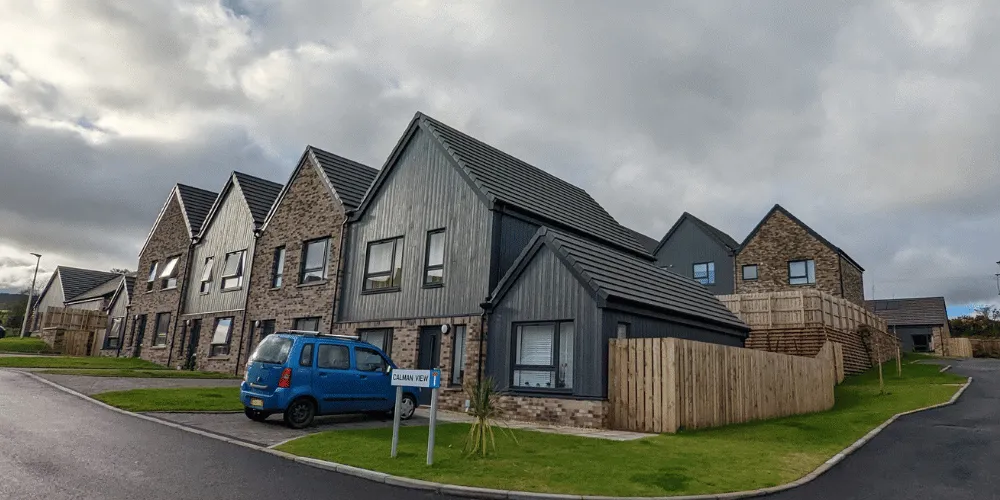 an image of a row of houses against a cloudy sky