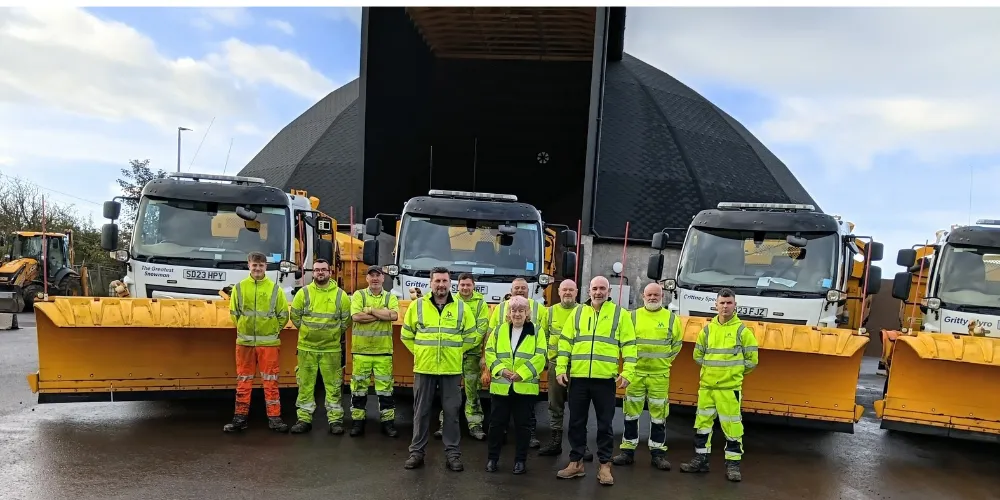 Councillor Collier with road staff and vehicles at the depot before the dry run