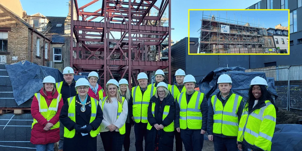 Councillors, Council staff and contractors lined up for a photo on a construction site